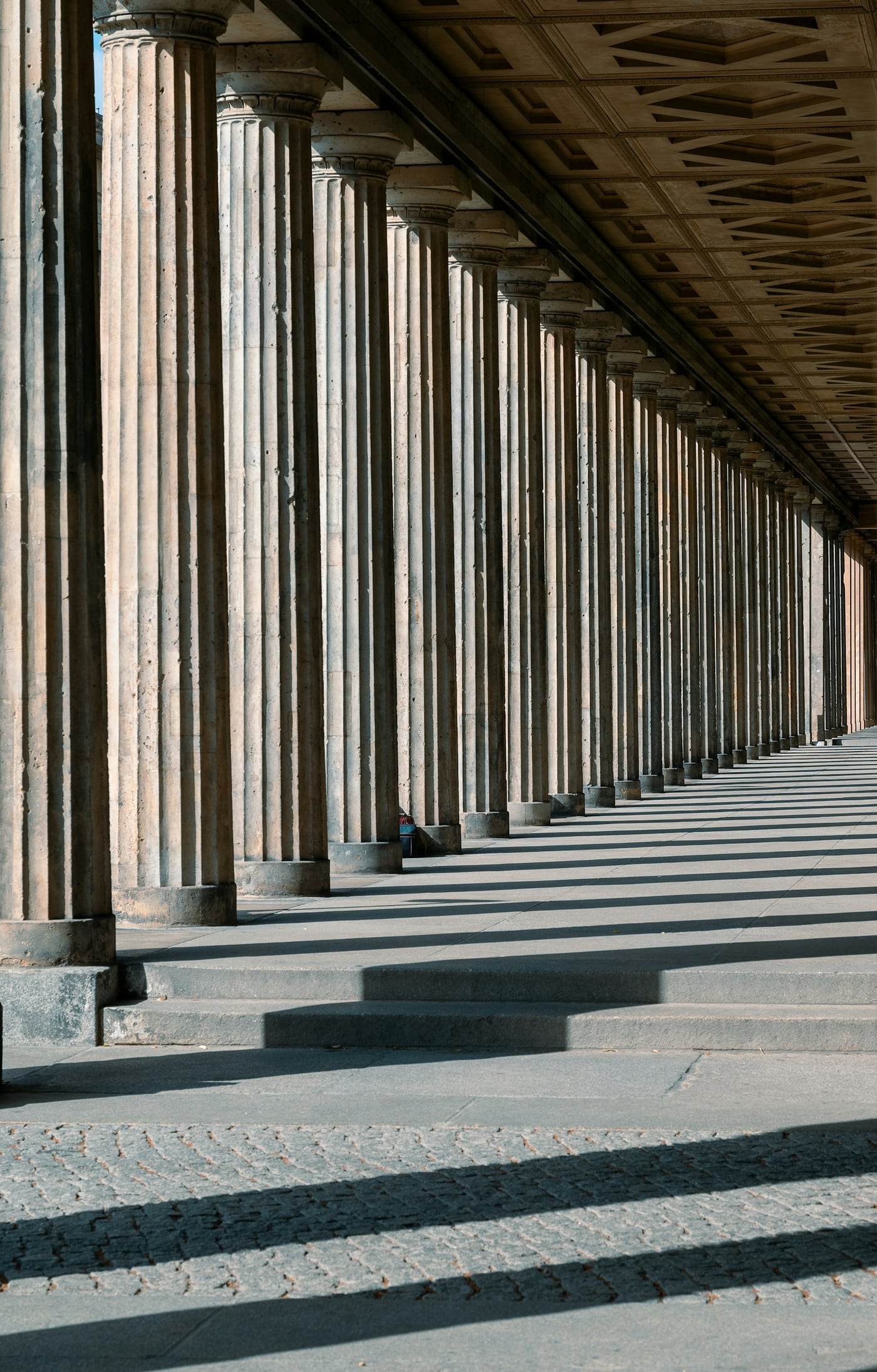 A stone colonnade receding into deep perspective